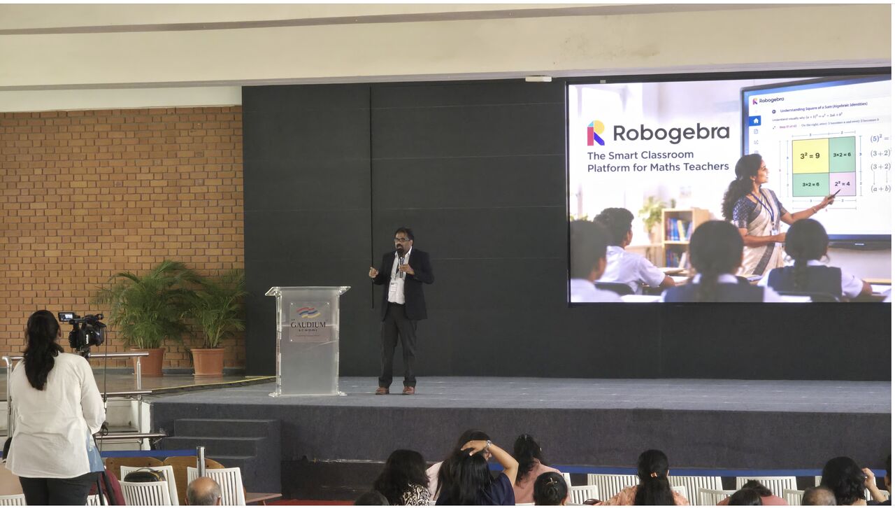 Ashraf presenting Robogebra on stage at Math Enclave, Gaudium School